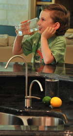 Young Boy drinking ionized water by kitchen sink!